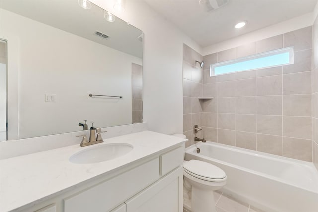 full bathroom featuring vanity, tile patterned floors, tiled shower / bath combo, and toilet