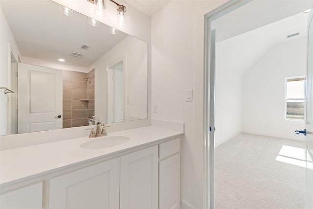 bathroom featuring vanity and a tile shower