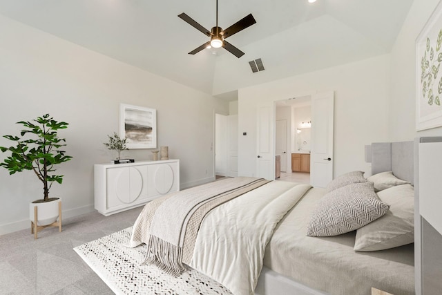 bedroom with light colored carpet, ensuite bath, ceiling fan, and lofted ceiling