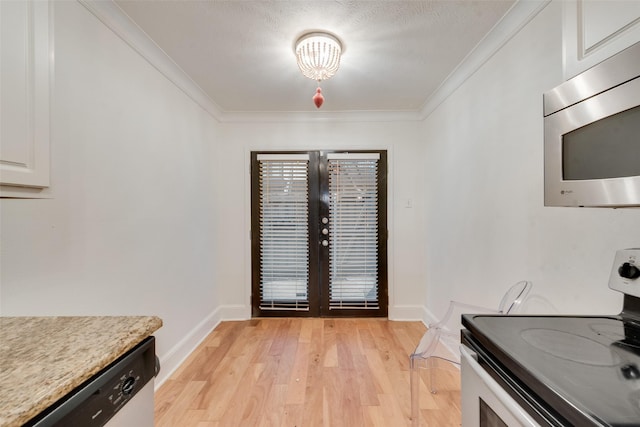 kitchen featuring white cabinets, appliances with stainless steel finishes, crown molding, and light hardwood / wood-style flooring