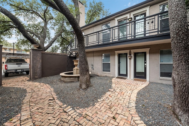 back of house with a balcony