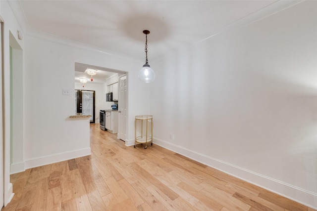 interior space with light hardwood / wood-style floors and crown molding