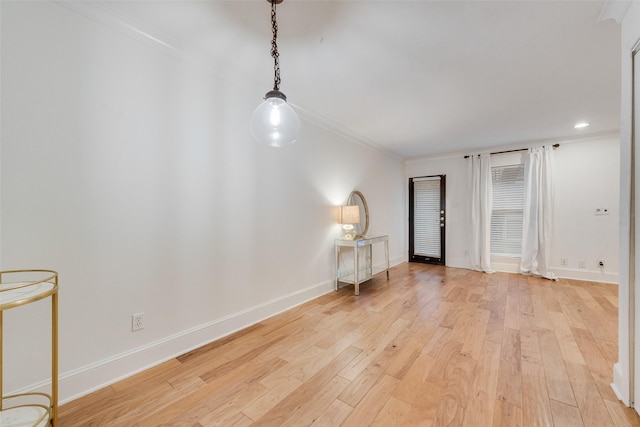 unfurnished room with ornamental molding and light hardwood / wood-style flooring