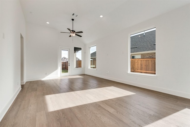 unfurnished living room featuring vaulted ceiling, light hardwood / wood-style flooring, and ceiling fan