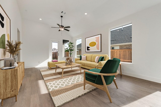 living room with wood-type flooring, ceiling fan, and vaulted ceiling