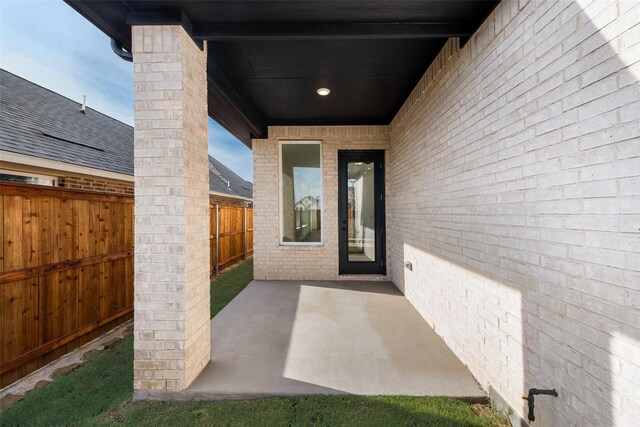 entrance to property featuring a patio