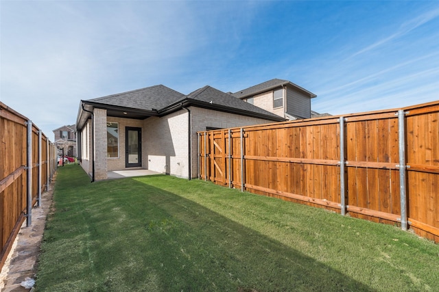 rear view of property with a lawn