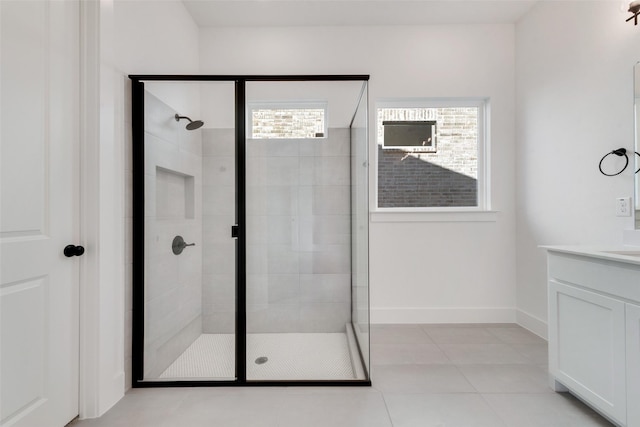 bathroom with tile patterned floors, vanity, and a shower with shower door