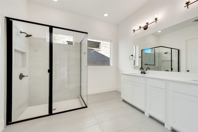 bathroom with tile patterned flooring, vanity, and an enclosed shower