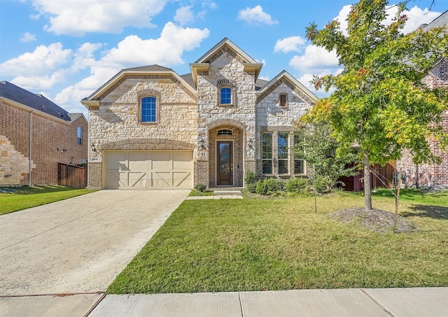 french country home with driveway, stone siding, a garage, and a front lawn