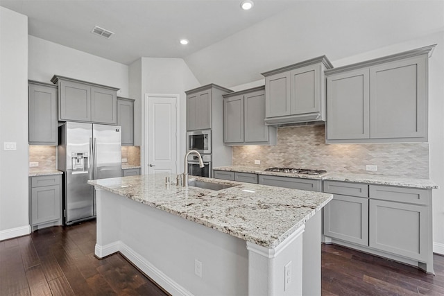 kitchen with light stone counters, gray cabinetry, visible vents, appliances with stainless steel finishes, and dark wood finished floors