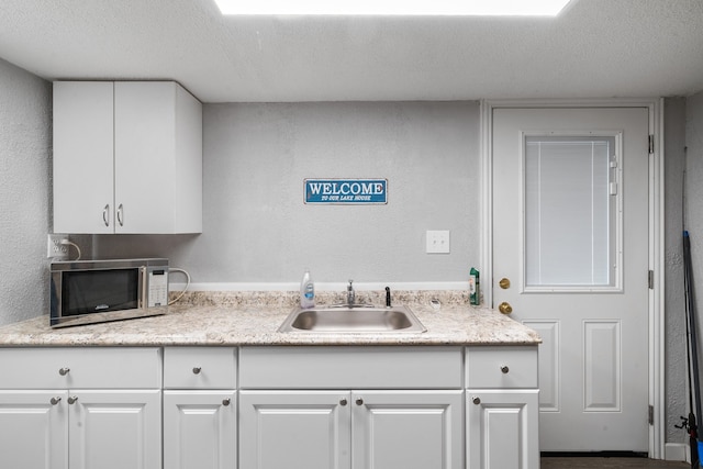 interior space featuring vanity and a textured ceiling