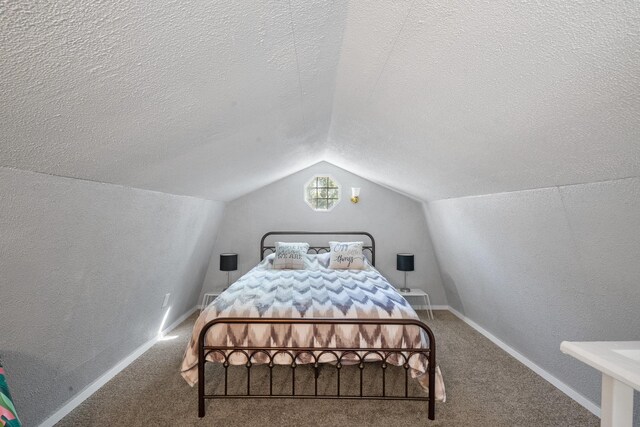 carpeted bedroom with vaulted ceiling and a textured ceiling