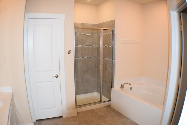 bathroom featuring tile patterned floors, vanity, and independent shower and bath