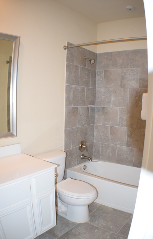 full bathroom featuring vanity, tile patterned floors, tiled shower / bath combo, and toilet