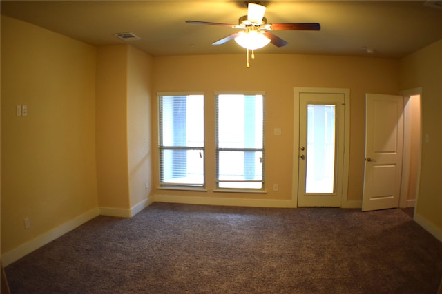 carpeted spare room featuring ceiling fan