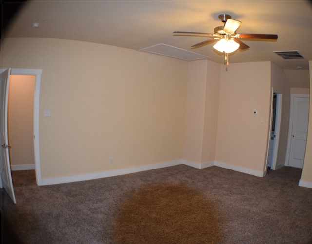 empty room with dark carpet and ceiling fan