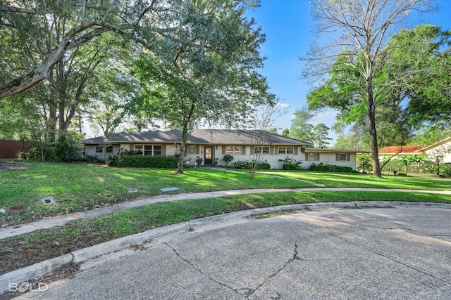 ranch-style home featuring a front yard