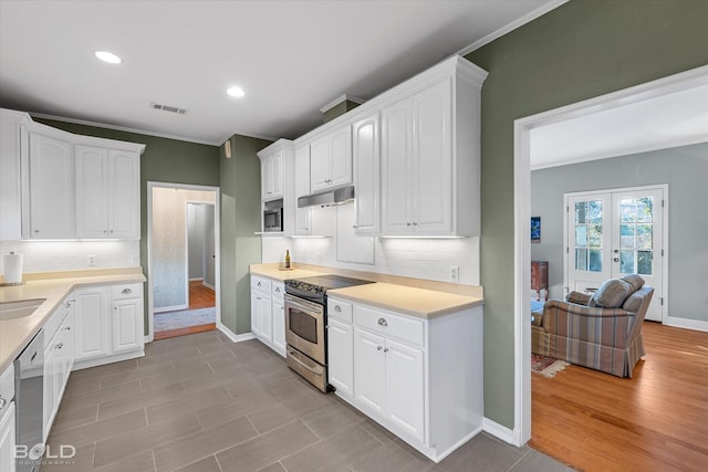 kitchen featuring light hardwood / wood-style floors, white cabinetry, and appliances with stainless steel finishes