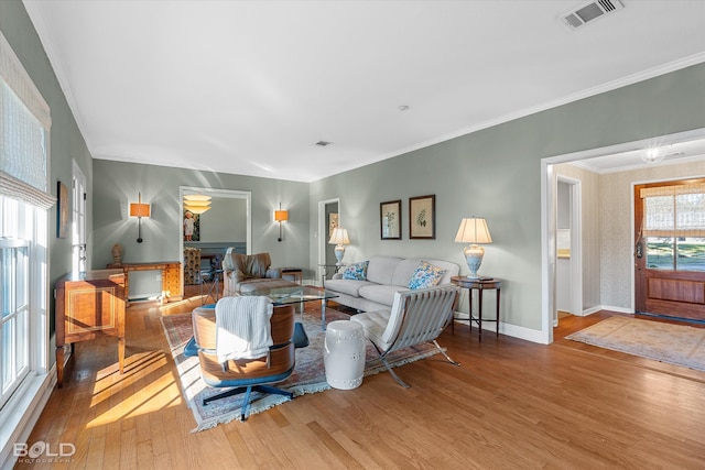 living room featuring ornamental molding and hardwood / wood-style flooring