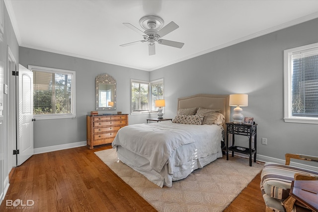 bedroom featuring hardwood / wood-style floors, ceiling fan, and ornamental molding