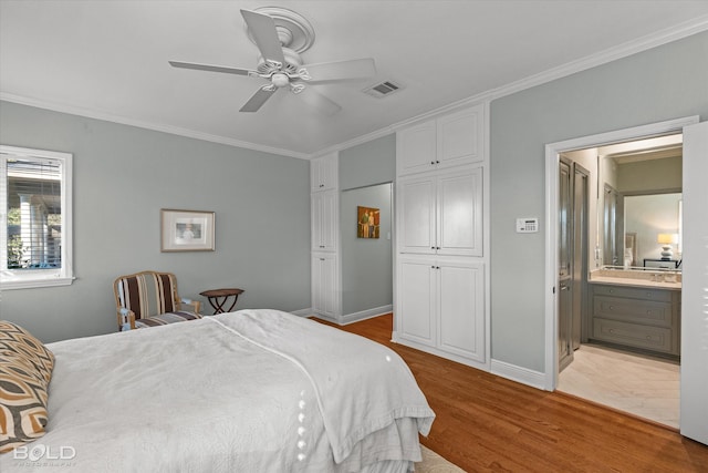 bedroom featuring ensuite bath, ceiling fan, crown molding, a closet, and light wood-type flooring