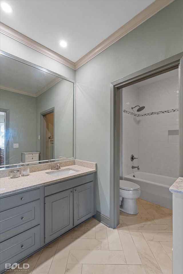 full bathroom with vanity, toilet, ornamental molding, and tiled shower / bath