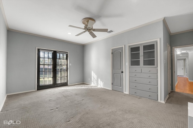 unfurnished bedroom with ceiling fan, light colored carpet, crown molding, and french doors