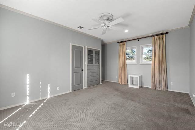 empty room featuring ceiling fan, carpet, and ornamental molding