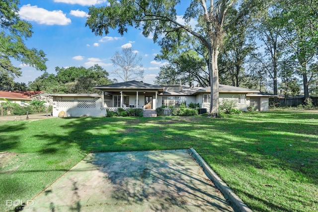 ranch-style house with a front yard and a porch