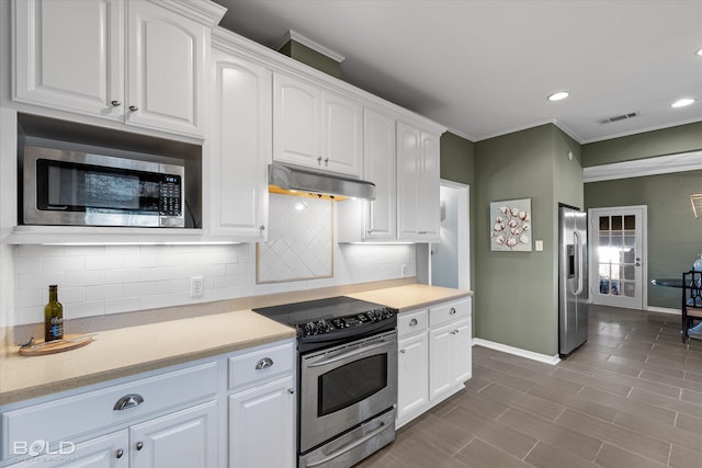 kitchen with tasteful backsplash, white cabinetry, and stainless steel appliances