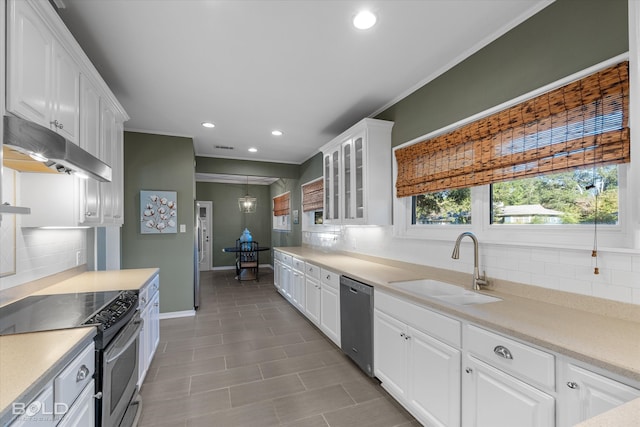 kitchen featuring tasteful backsplash, white cabinetry, sink, and appliances with stainless steel finishes