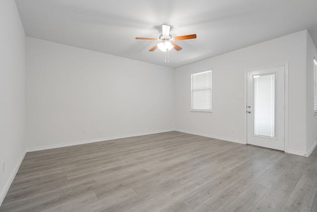 spare room with ceiling fan and light wood-type flooring