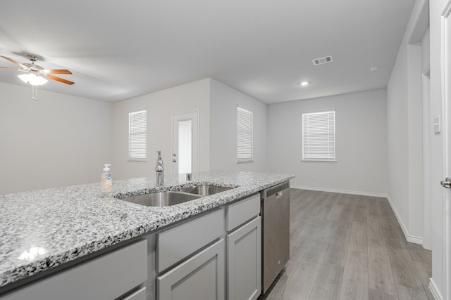 kitchen featuring dishwasher, plenty of natural light, sink, and light hardwood / wood-style flooring