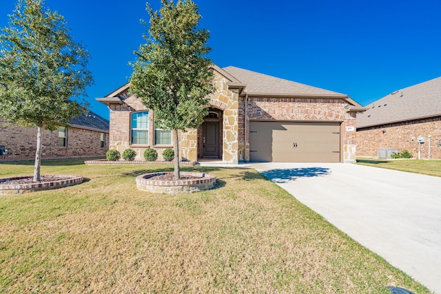 view of front of property with a garage and a front lawn