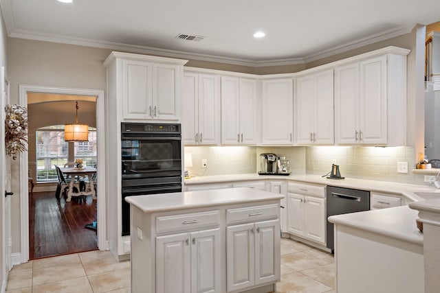 kitchen featuring light hardwood / wood-style flooring, white cabinets, black double oven, and ornamental molding