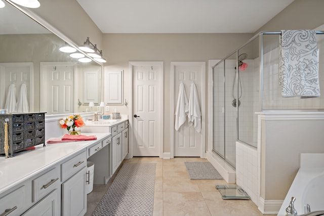 bathroom featuring tile patterned flooring, vanity, and an enclosed shower