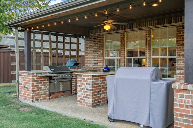 view of patio / terrace with a grill, ceiling fan, and exterior kitchen