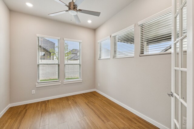 empty room featuring ceiling fan and hardwood / wood-style floors