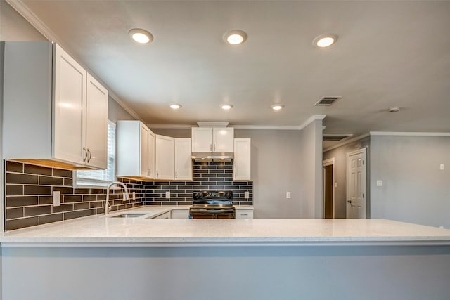 kitchen with black range, sink, ornamental molding, white cabinetry, and kitchen peninsula