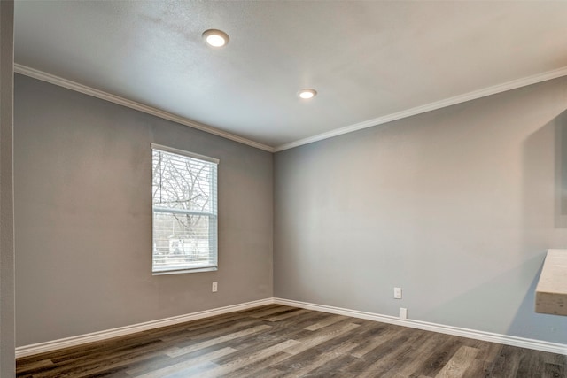 empty room with dark hardwood / wood-style floors and ornamental molding