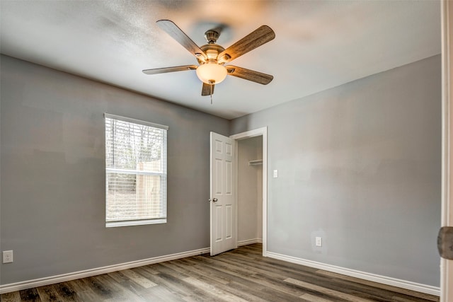 spare room with ceiling fan and hardwood / wood-style flooring