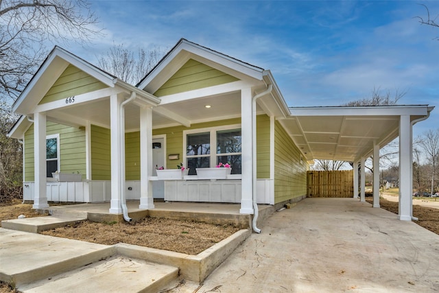 view of front of house featuring a porch and a carport