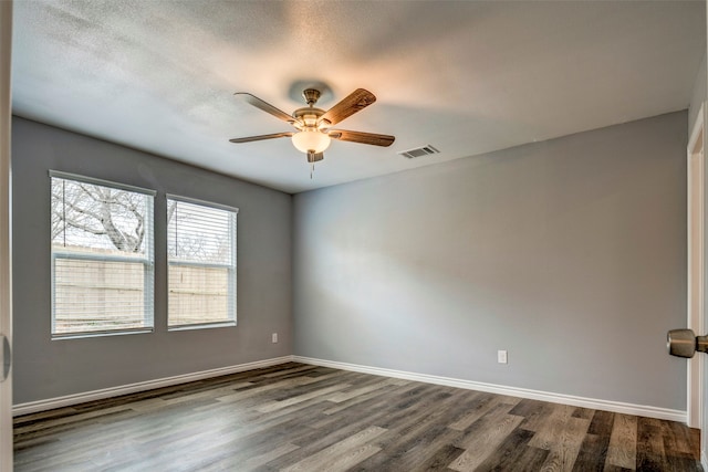 unfurnished room with hardwood / wood-style floors, ceiling fan, and a textured ceiling