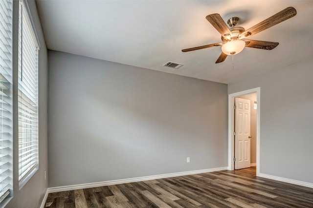 unfurnished room with dark hardwood / wood-style floors and ceiling fan