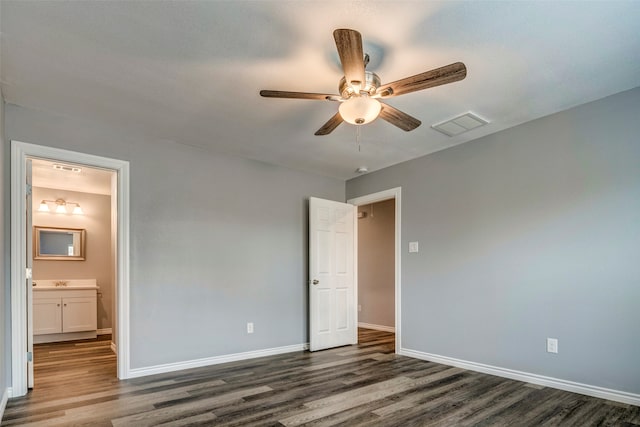 unfurnished bedroom featuring dark hardwood / wood-style floors, ensuite bath, ceiling fan, and sink