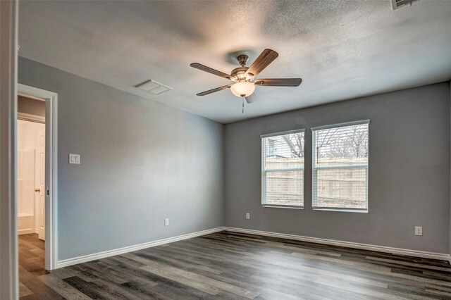 unfurnished room featuring a textured ceiling, ceiling fan, and dark hardwood / wood-style floors