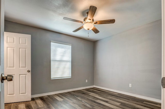 unfurnished room featuring ceiling fan and dark hardwood / wood-style flooring