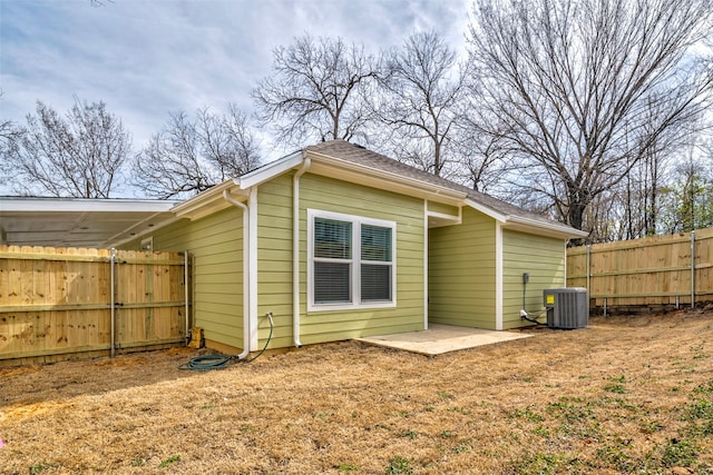 rear view of house featuring cooling unit