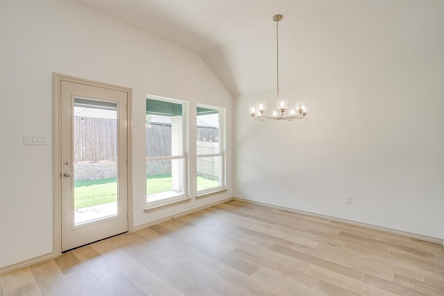 interior space with lofted ceiling, a wealth of natural light, and light hardwood / wood-style flooring